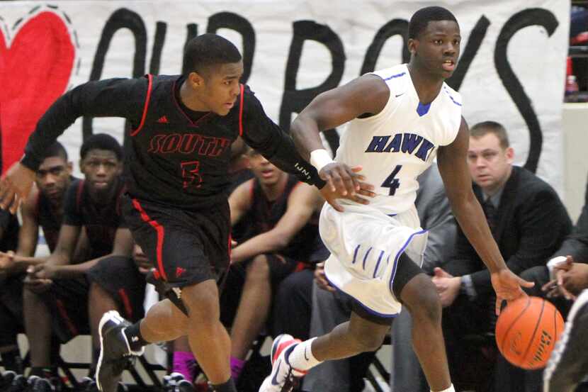 Hebron's Jeremy Hicks (4) drives down the court as he is defended by South Grand Prairie's...