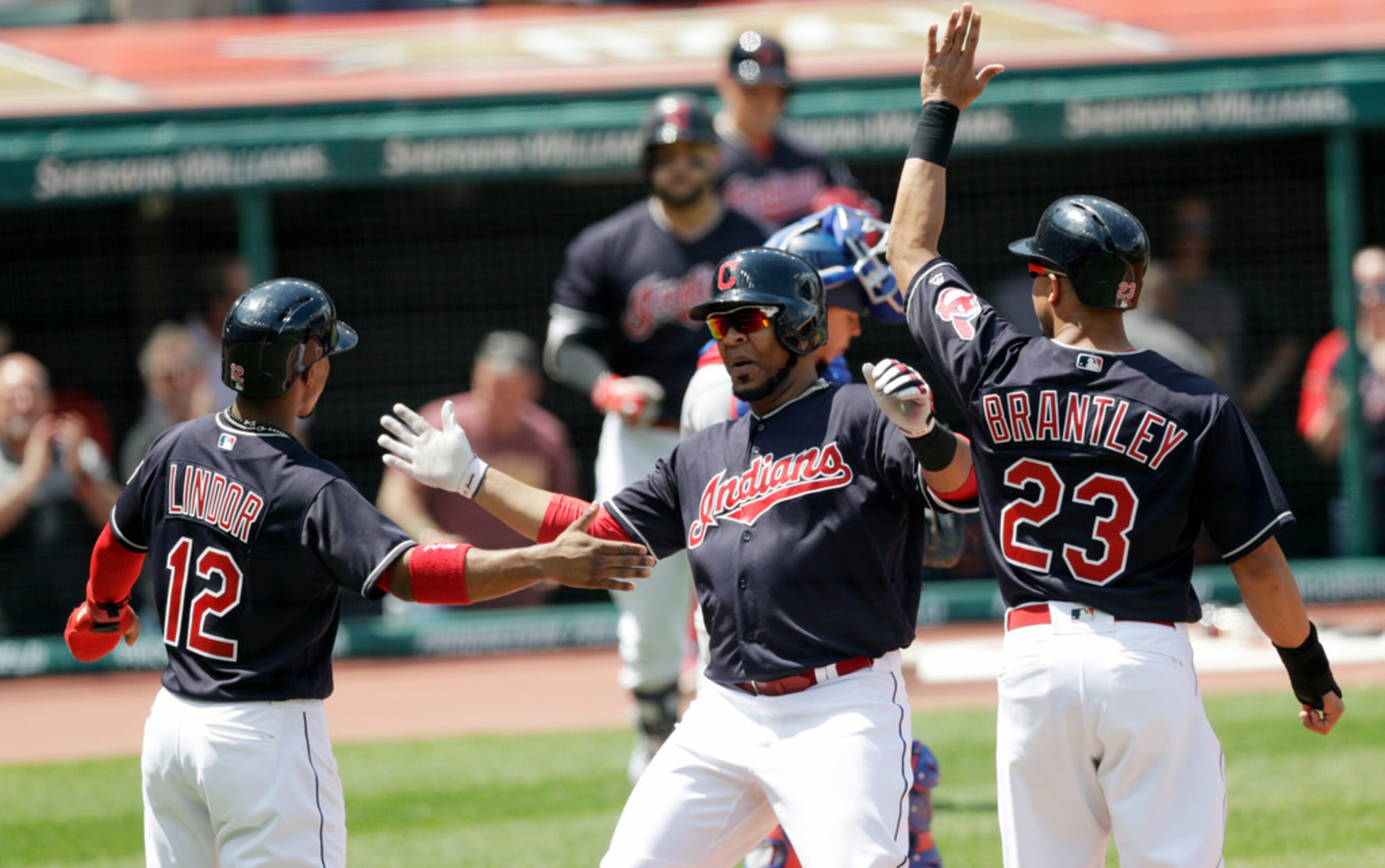 Cleveland Indians' Edwin Encarnacion, center, celebrates with Michael Brantley and Francisco...