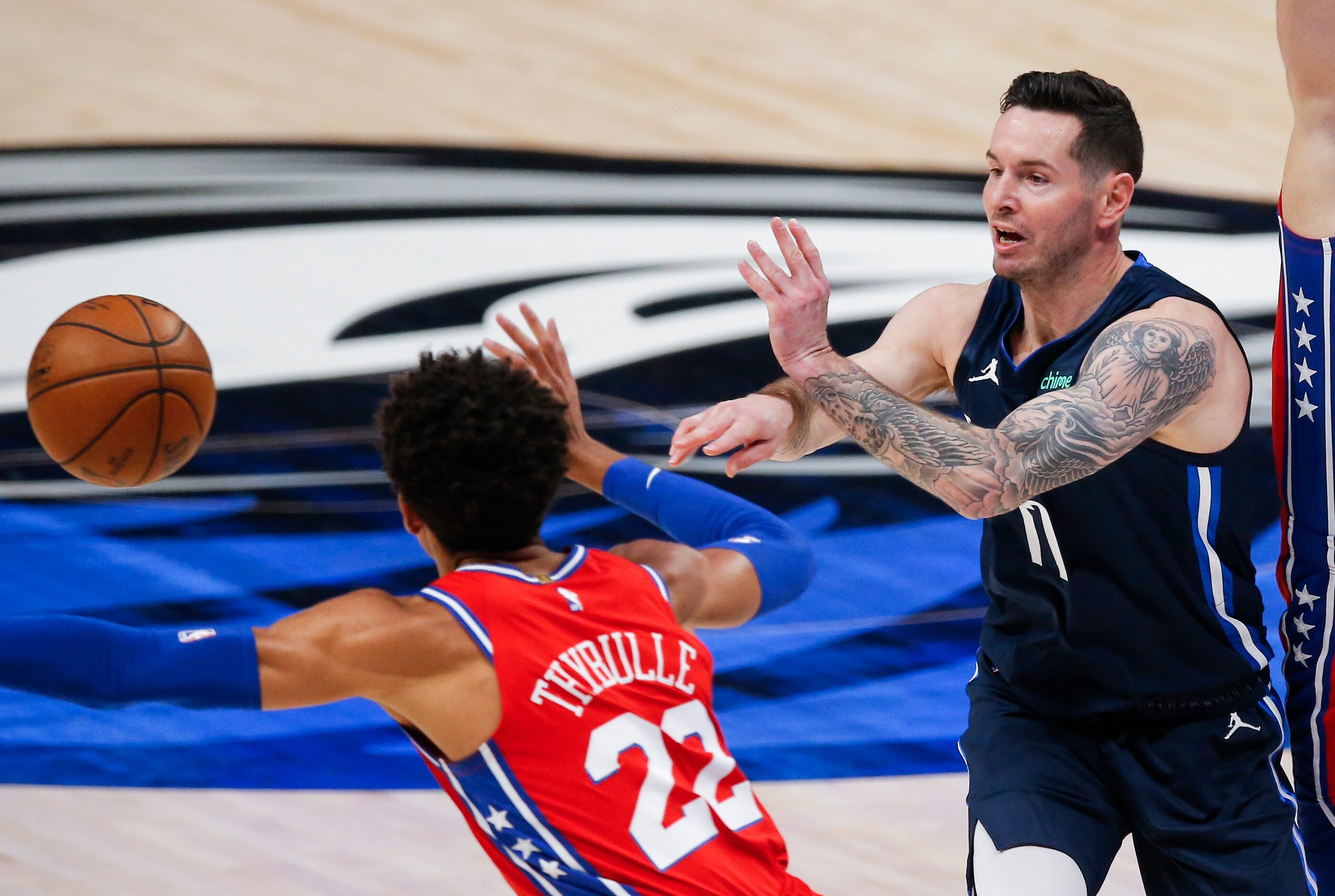 Dallas Mavericks guard JJ Redick (17) passes as Philadelphia 76ers guard Matisse Thybulle...