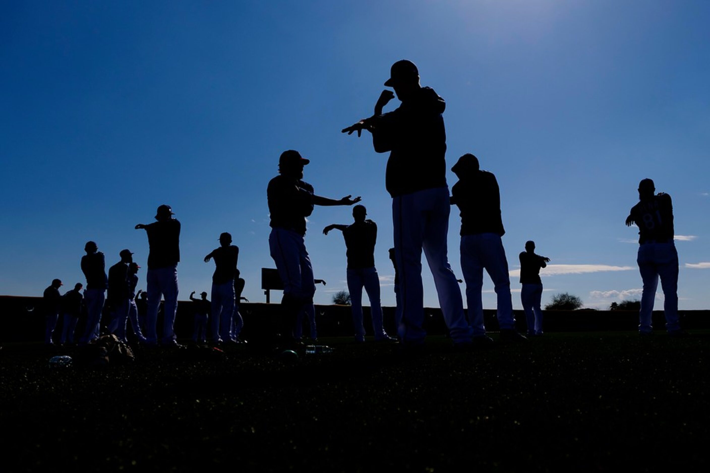 Texas Rangers pitcher Chris Martin (front) stretches with his teammates during a spring...