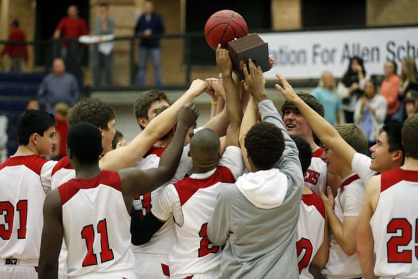 Flower Mound Marcus High School hoists up the championship trophy after defeating Heritage...