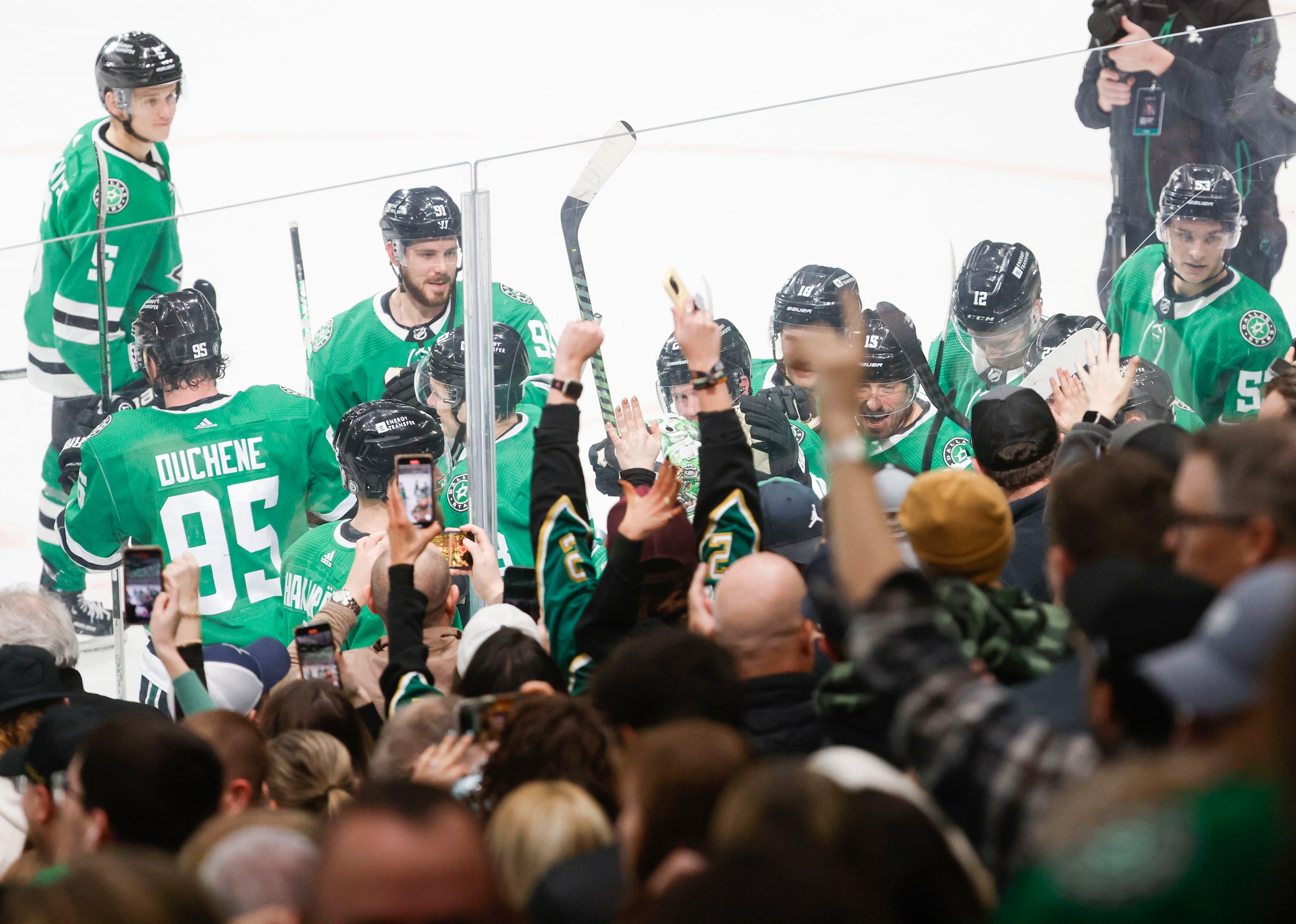 Crowd cheers as Dallas Stars center Roope Hintz (24) celebrates with Miro Heiskanen (4) and...