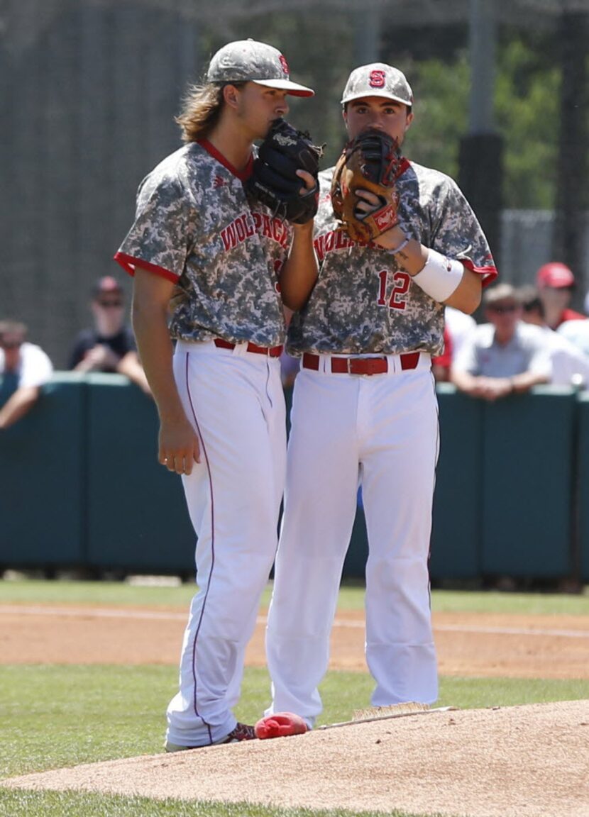 North Carolina State's Preston Palmeiro, right, talks with Evan Brabrand (31) in the ninth...