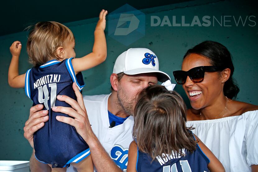 Dallas Mavericks Dirk Nowitzki kisses his 3-year-old daughter Malaika Nowitzki (second from...