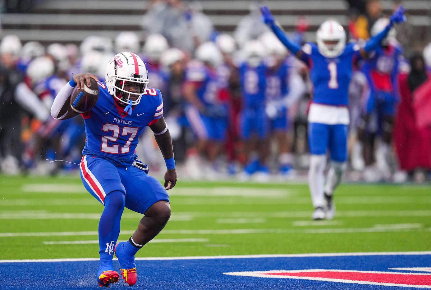 Duncanville running back JaQualon Armstrong (27) celebrates after scoring on a 15-yard...