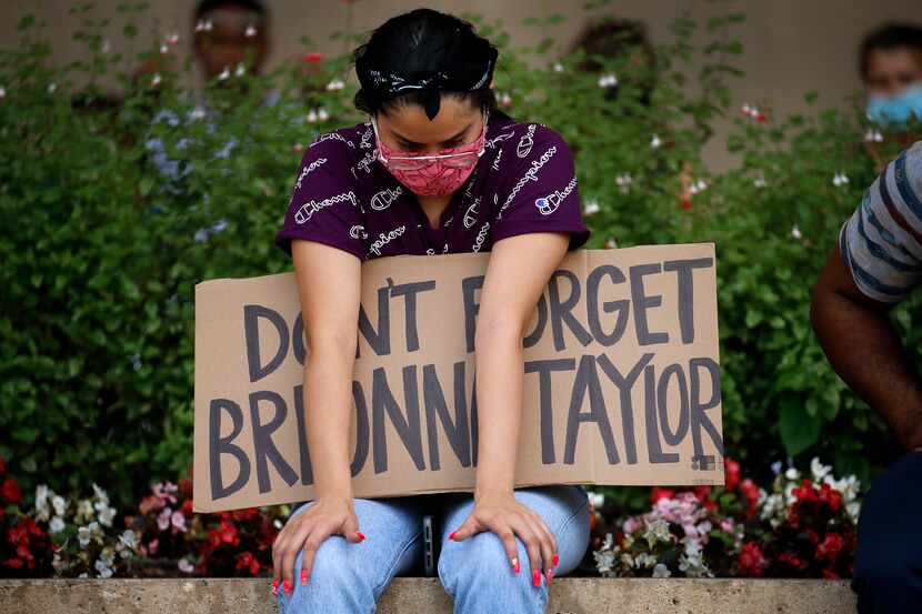 A protester supporting Breonna Taylor, the Kentucky woman fatally shot by police in March,...