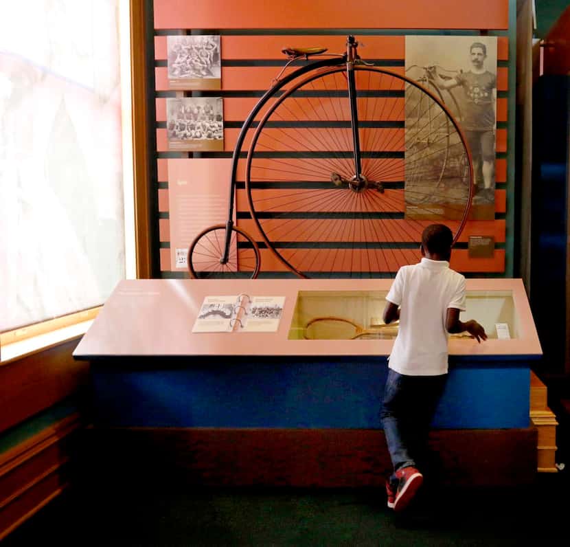 A boy looks  at an exhibit at the museum. The original museum plan was seen as a way to...