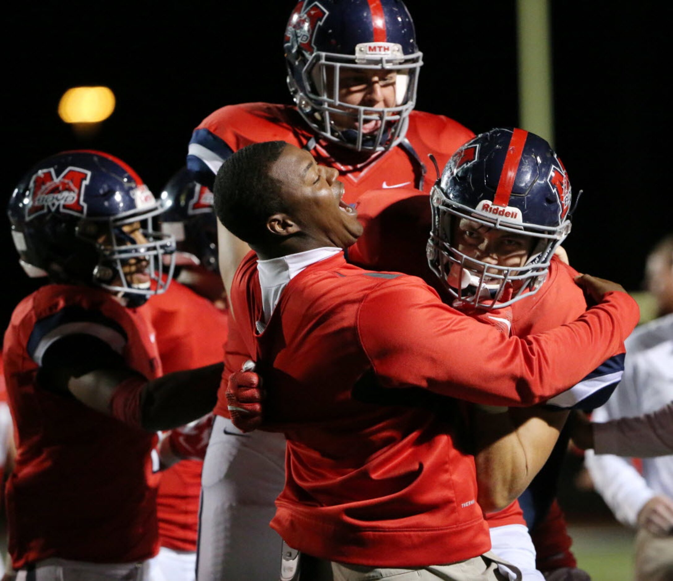 McKinney Boyd assistant coach Robert Boone hugs defensive back Parker Noren (9) after Noren...