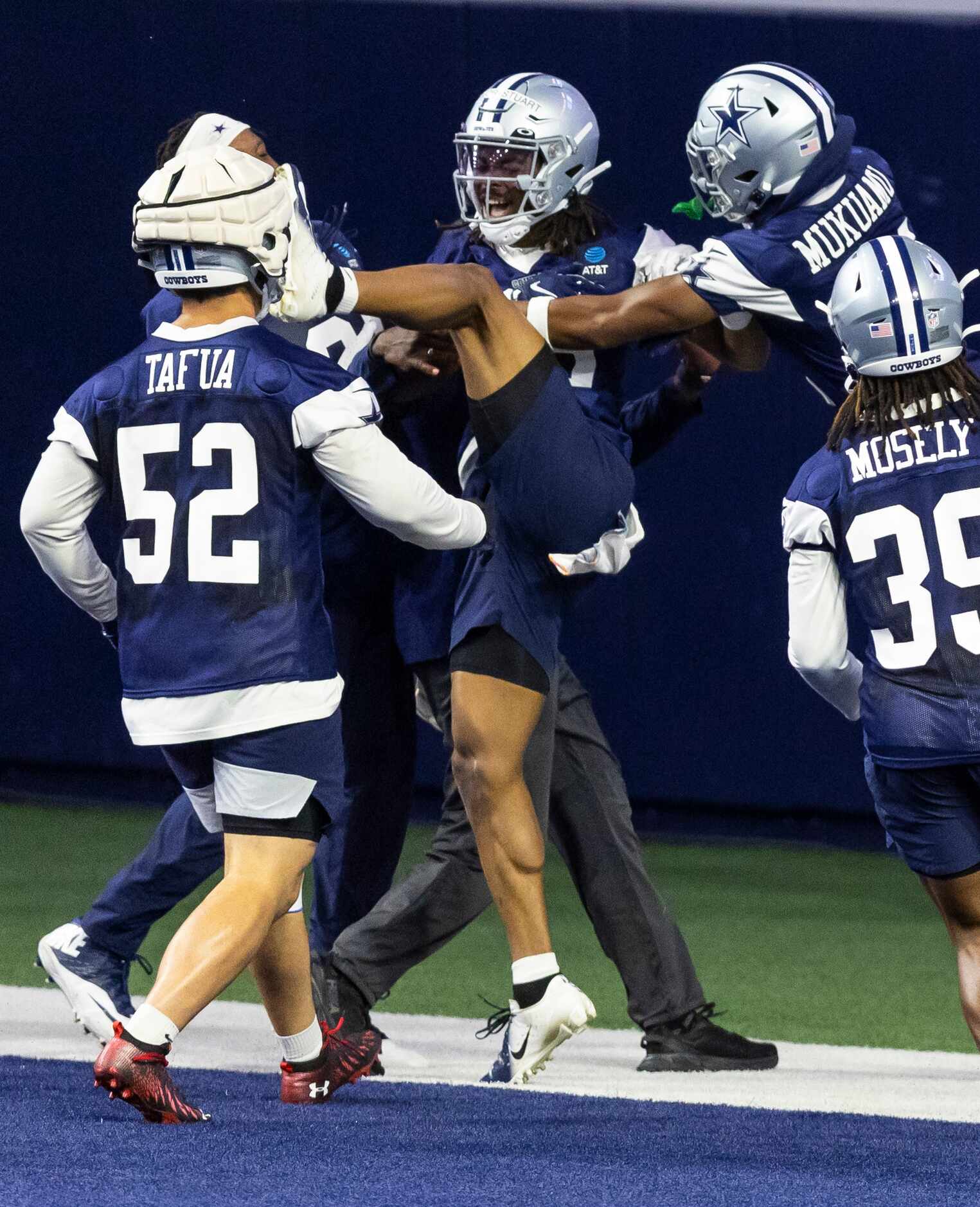 Dallas Cowboys cornerback Isaac Taylor-Stuart, center, is congratulated by teammates after...
