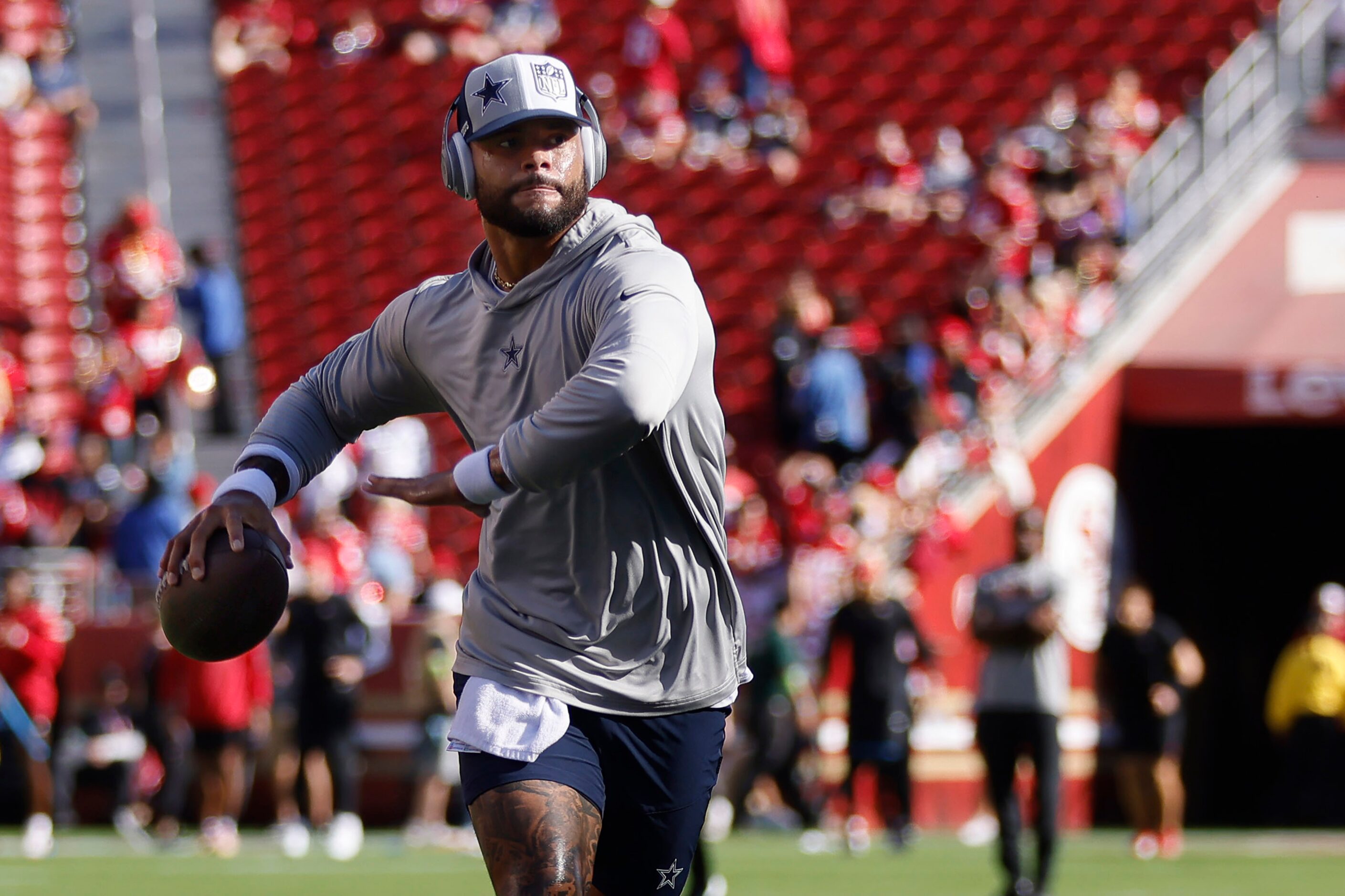 Dallas Cowboys quarterback Dak Prescott (4) rolls out and throws during pregame warmups...