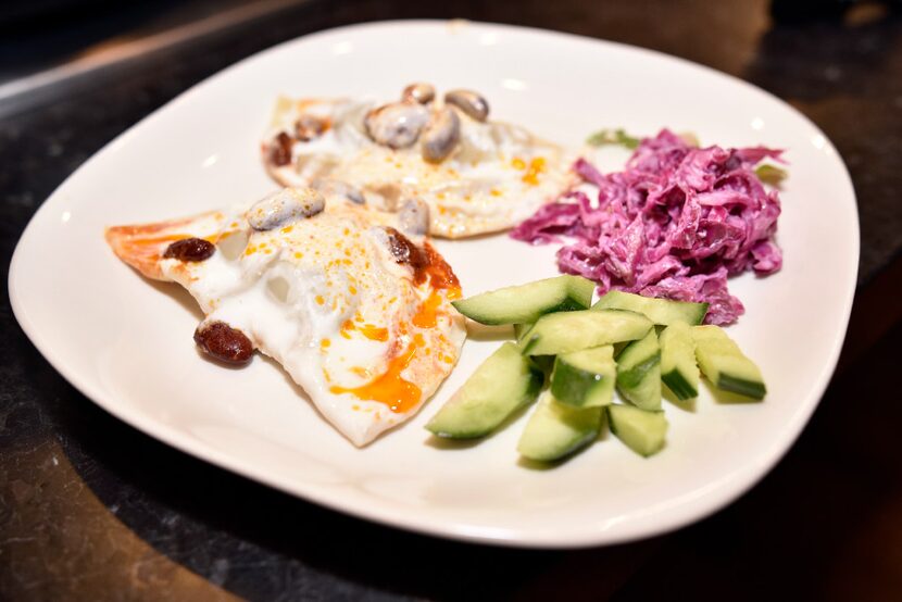 A dish of mantu (beef dumpling) and Afghan salad 