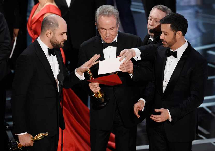 "La La Land" producer Jordan Horowitz, left, presenter Warren Beatty, center, and host Jimmy...