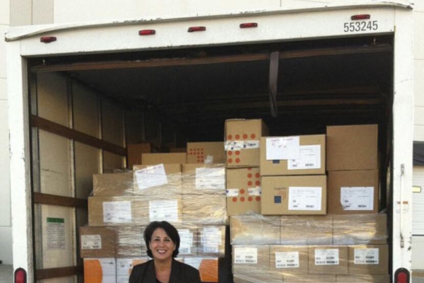 Karen Furlong sits in a truck loaded with books that are bound for children in Rio Grande...
