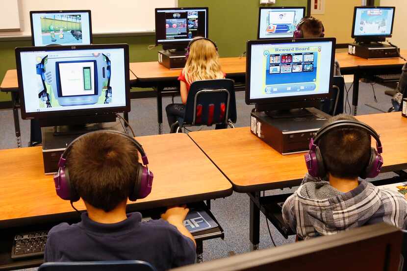Students at a summer reading academy work in the computer lab at Buchanan Elementary School...