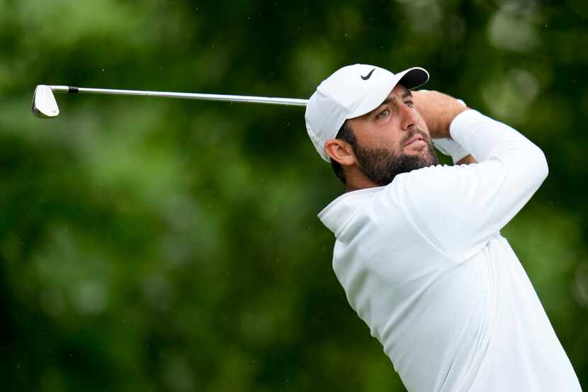 Scottie Scheffler watches his tee shot on the 11th hole during the second round of the PGA...