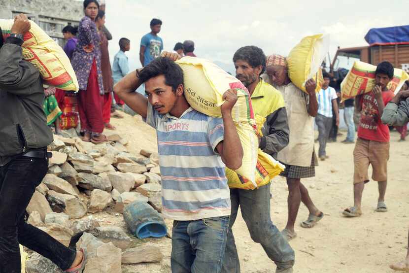 
Residents of Nepal’s Kathmandu Valley transport relief supplies in the aftermath of the...