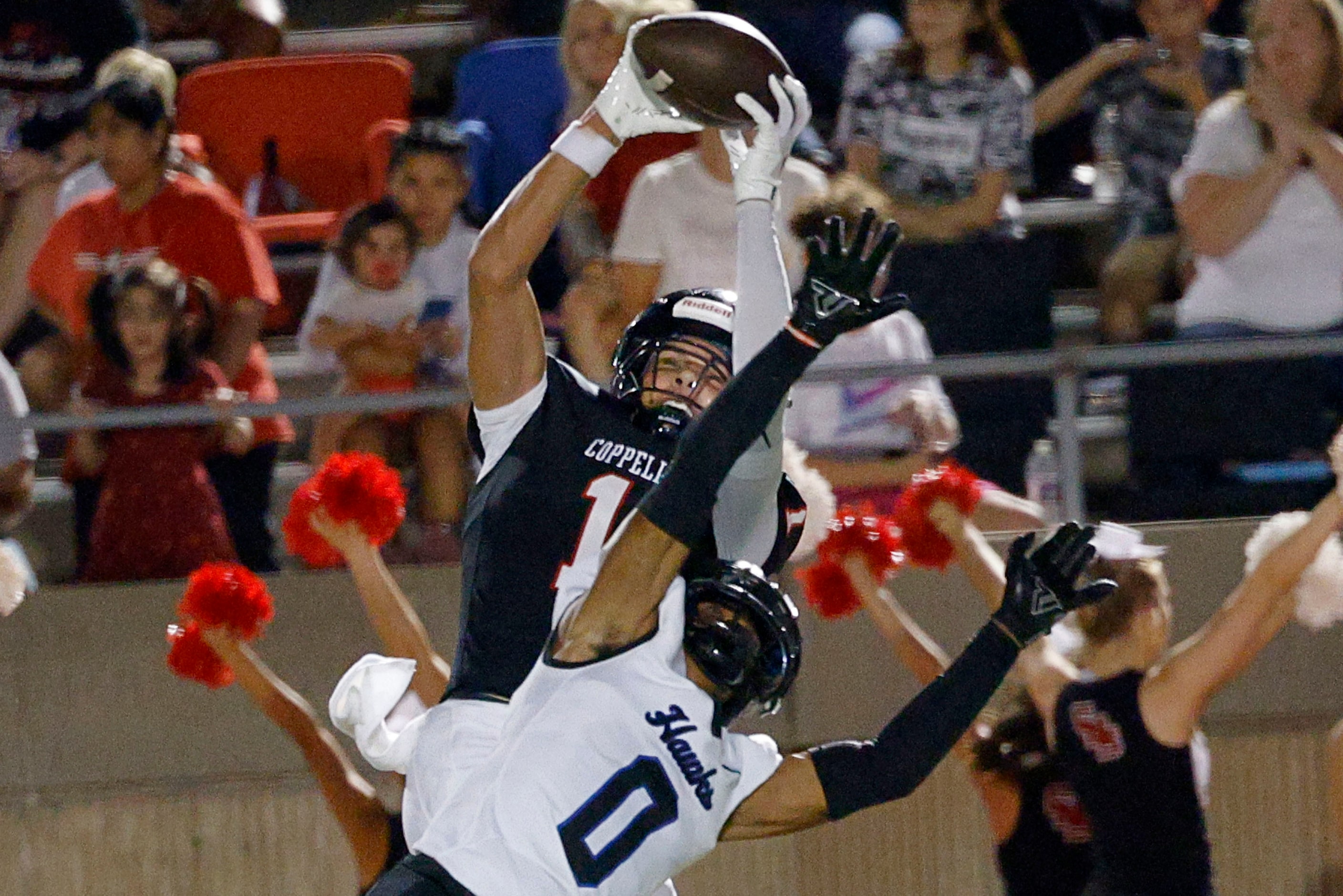 Coppell's Tucker Cusano (1) catches a pass against Hebron's Gabriel White (0) and runs for a...