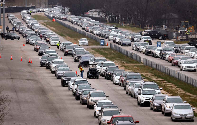 Vehicles lined up in Fair Park in February as residents flocked to receive COVID-19...