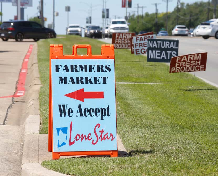 Signs along Garland Road point the way to the White Rock Lake Farmers Market.