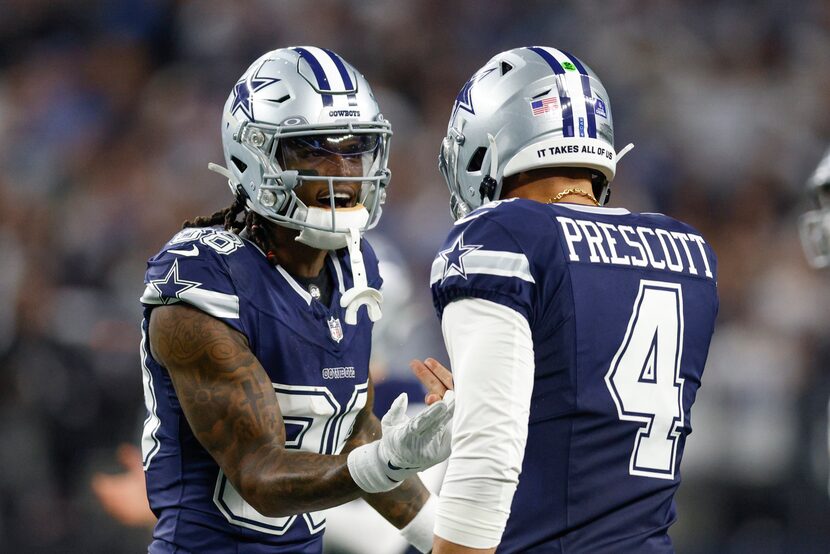 Dallas Cowboys wide receiver CeeDee Lamb (88) celebrates with quarterback Dak Prescott (4)...