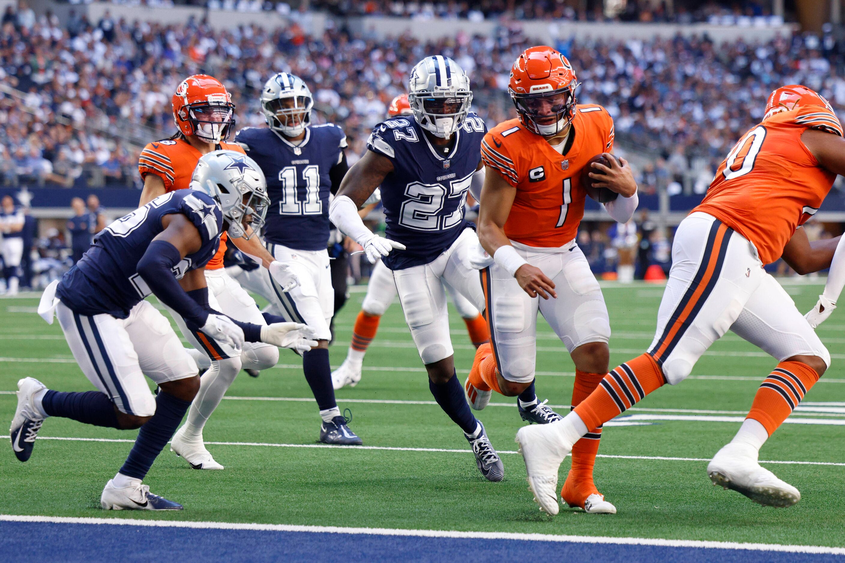 Chicago Bears quarterback Justin Fields (1) runs for a touchdown ahead of Dallas Cowboys...