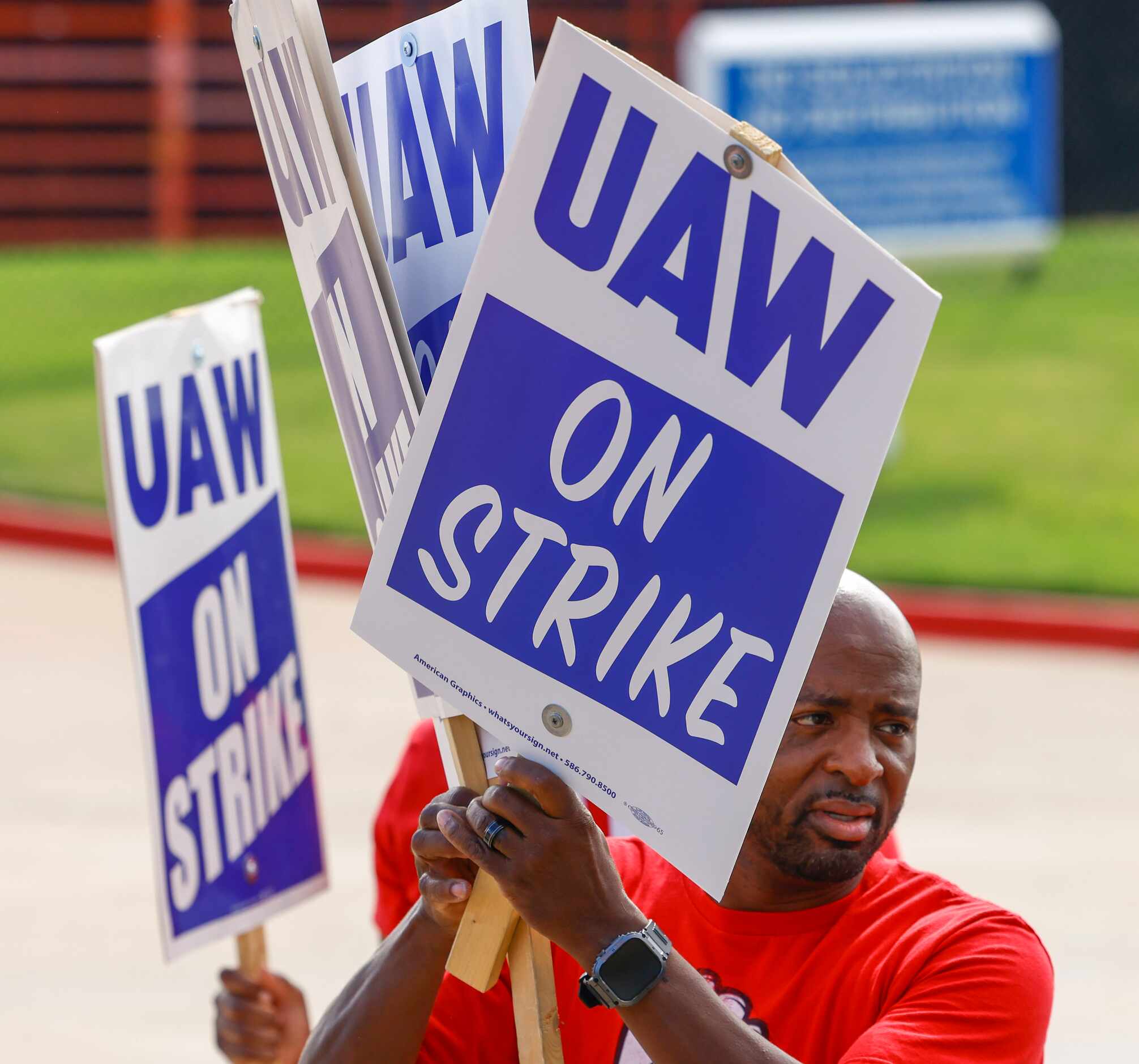 UAW local 816 president Cornelius Lincoln distribute signs to the employees ahead of a...