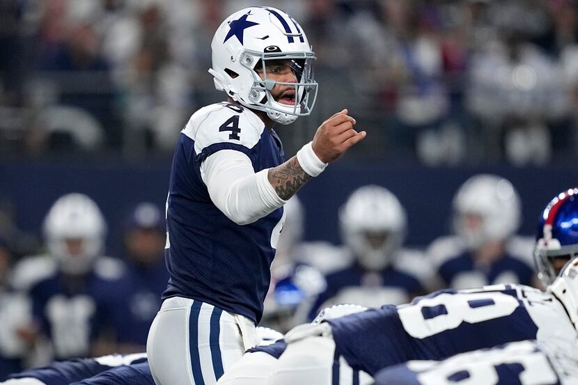 Dallas Cowboys quarterback Dak Prescott signals at the line of scrimmage during an NFL...