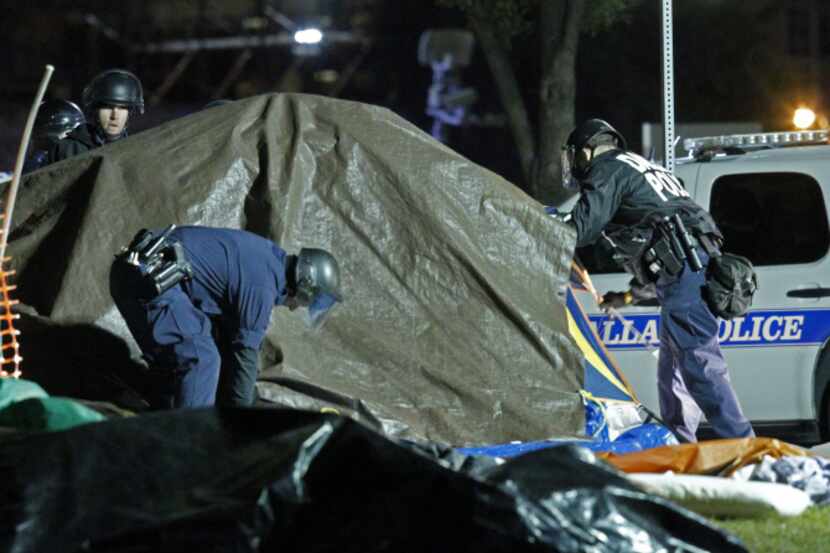Police officers descended upon the Occupy Dallas campsite across from City Hall in 2011 with...