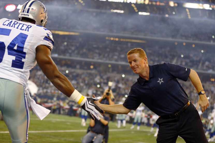 Dallas Cowboys head coach Jason Garrett high-fives defensive back Jakar Hamilton before a...