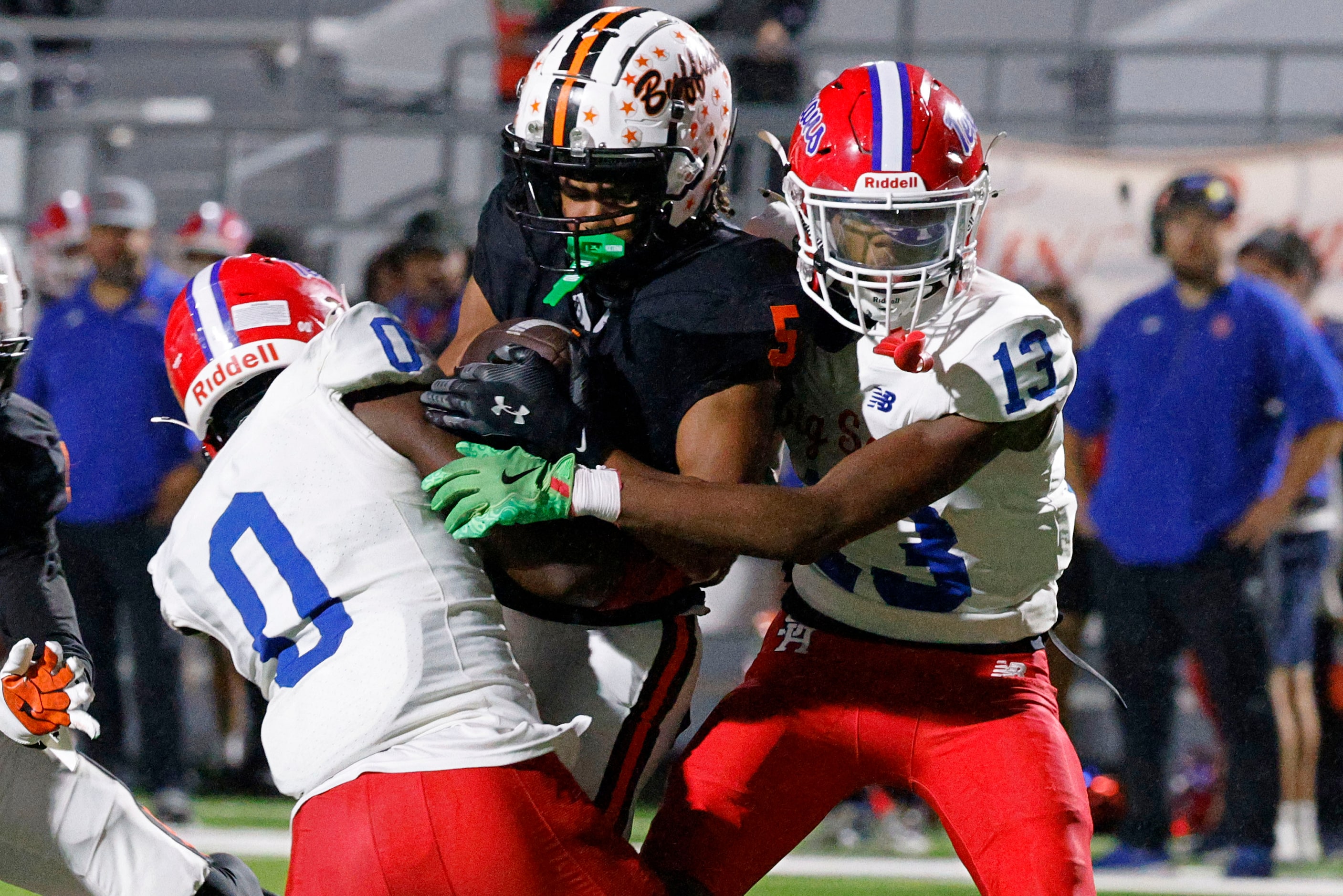 Haltom's Vudrico Roberson (5) keeps the ball away from Sam Houston's Naftali Gekonge (0) and...