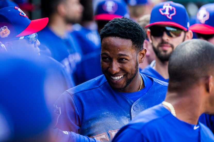 Texas Rangers third baseman Jurickson Profar (19) smiles as he enters the dugout after...