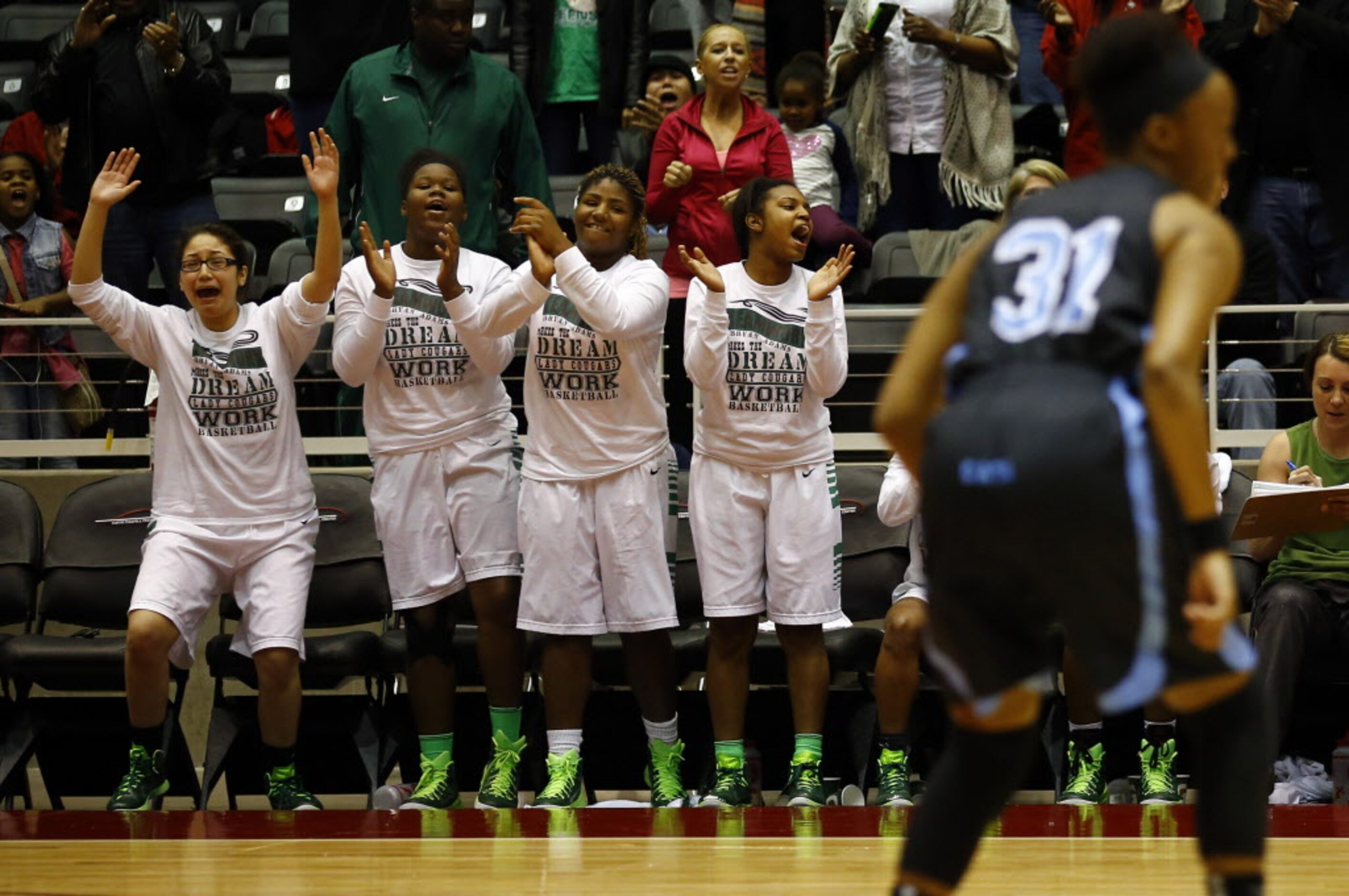 The Bryan Adams bench celebrates as Arlington Seguin's Morgan Newton (31) plays during the...