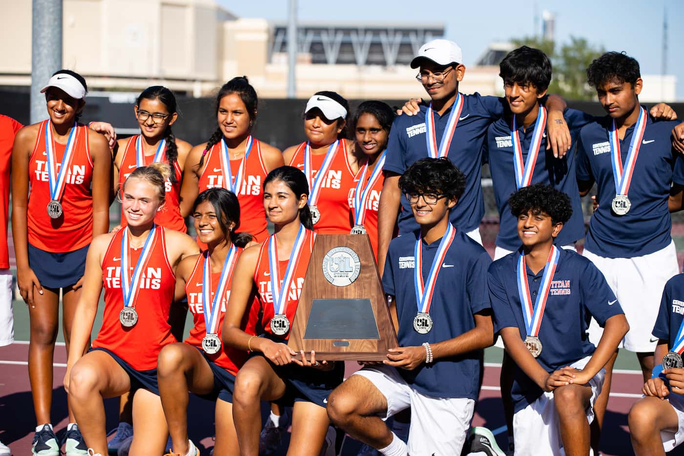 Members of the Frisco Centennial tennis team pose for a group photo at the conclusion of the...