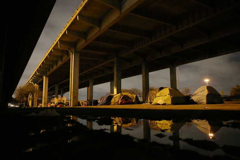 Tent City stretches under the I-45 overpass that runs along Louise Avenue, Dawson Street and...