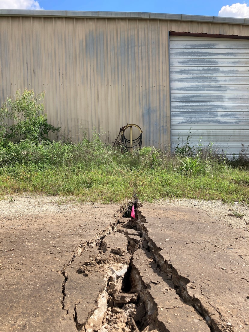 Cracks and other damage caused by a sinkhole in Daisetta can be seen around a shuttered oil...