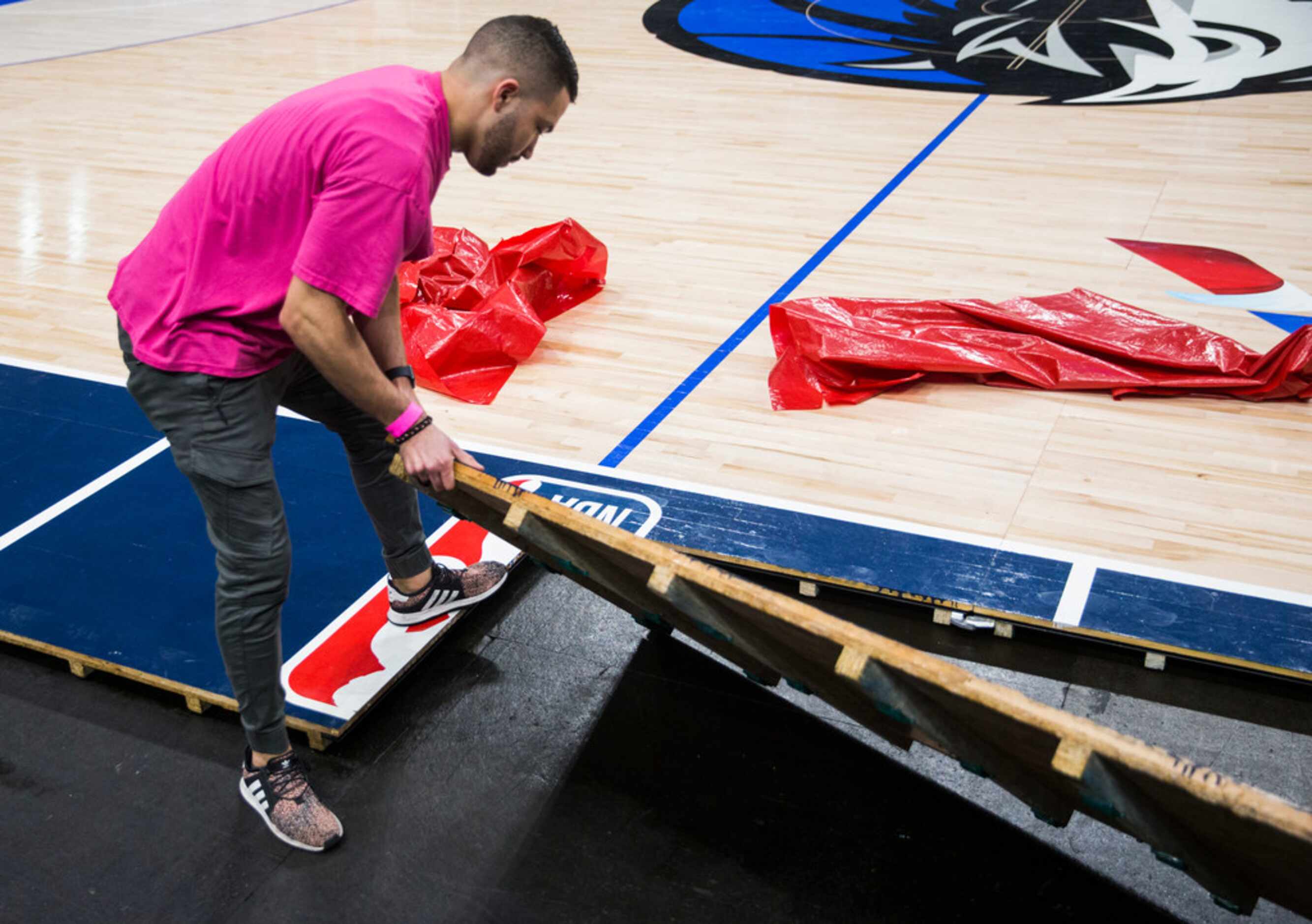 Crews break down the court after the Dallas Mavericks beat the Denver Nuggets 113-97 on...