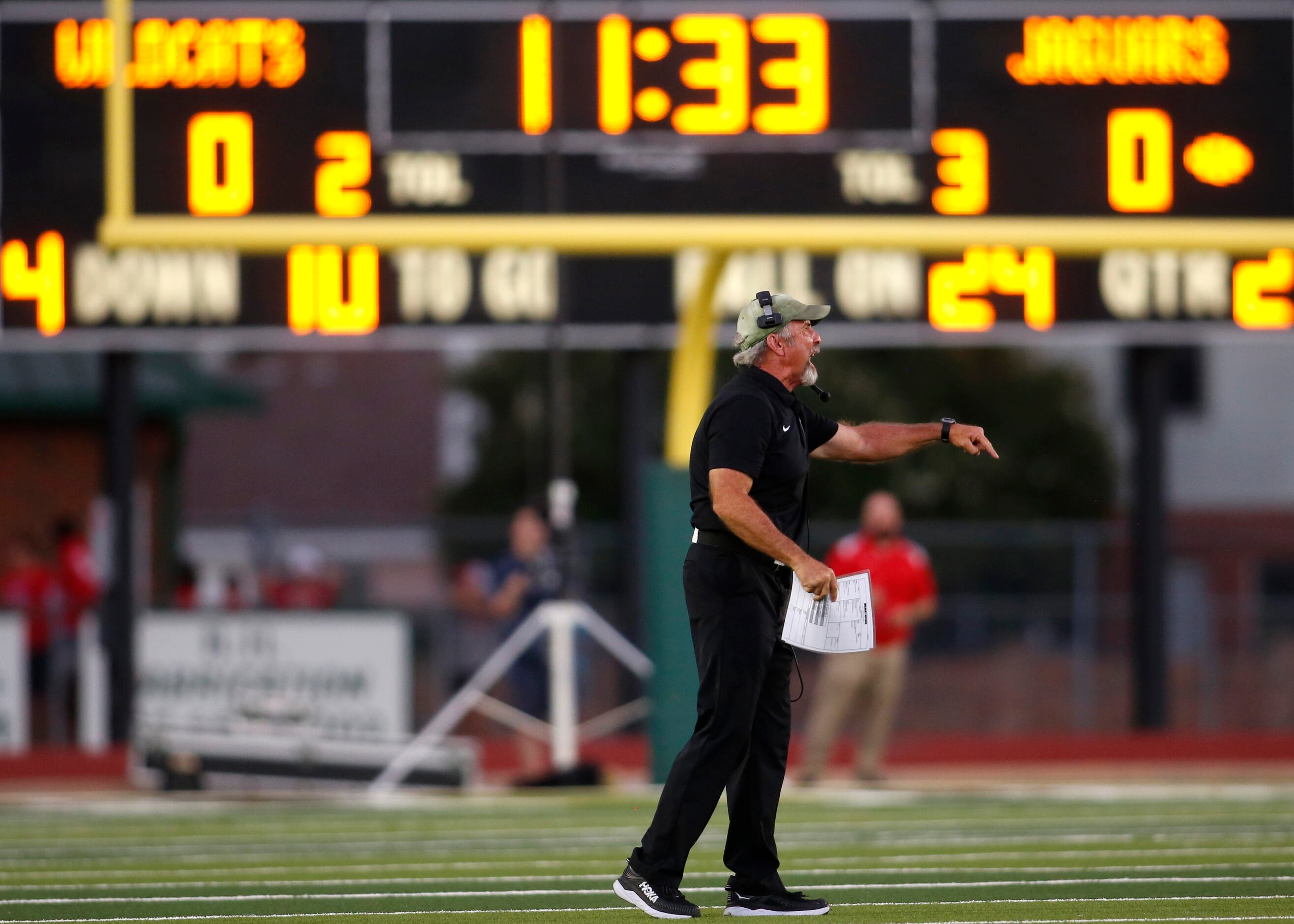 Kennedale head coach Richard Barrett makes a point with a game official between plays of...