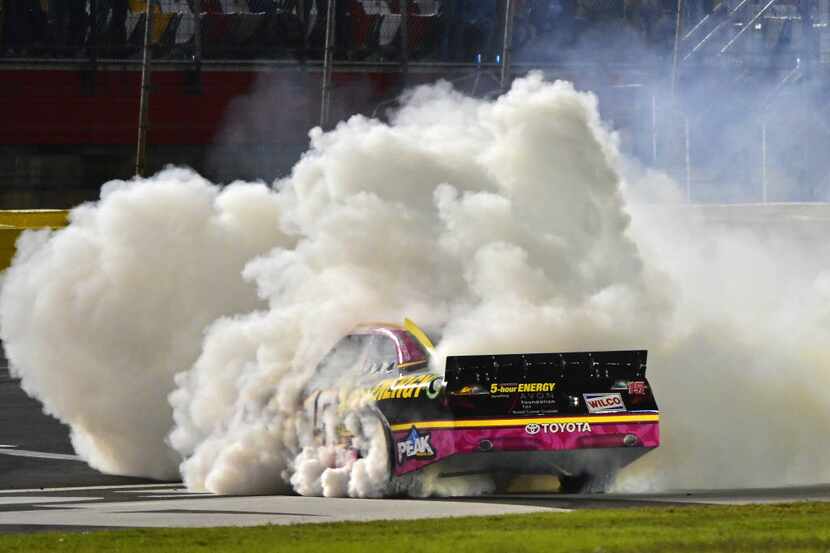 Clint Bowyer does a Victory burnout after winning the NASCAR Sprint Cup Series auto race at...