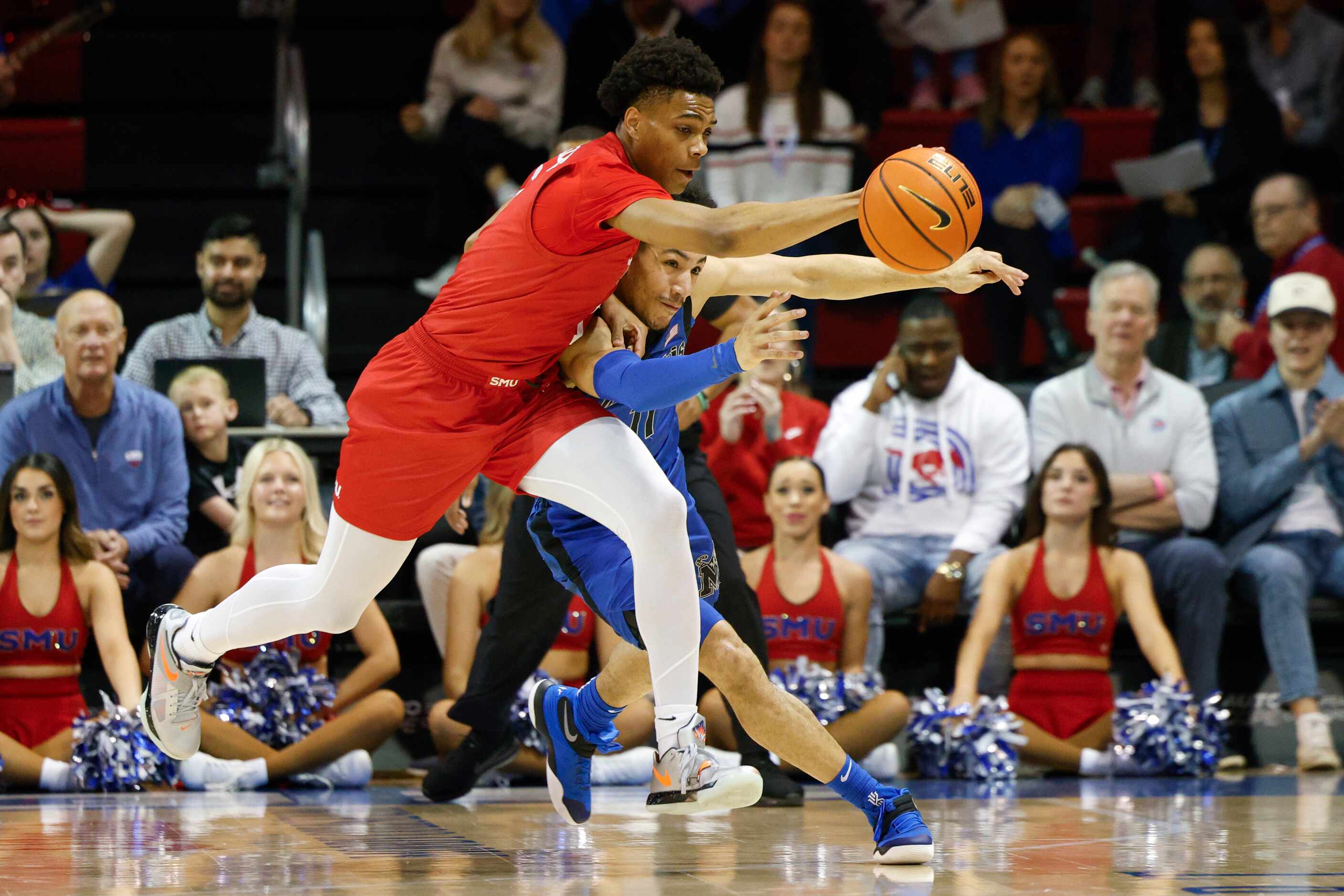 SMU guard Zhuric Phelps (1) and Memphis guard Jahvon Quinerly (11) chase after a loose ball...