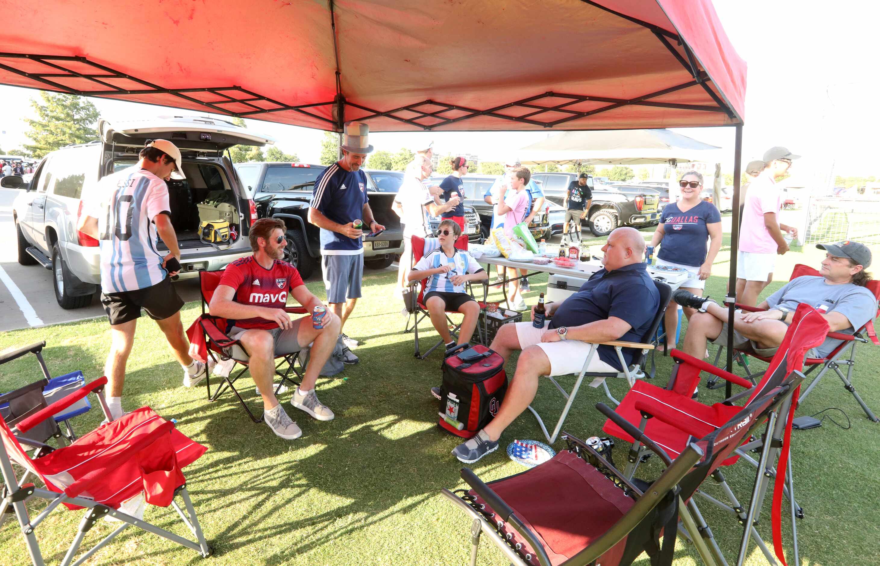 Fans enjoy some food and fun as they wait for the gates to open for an FC Dallas game at...
