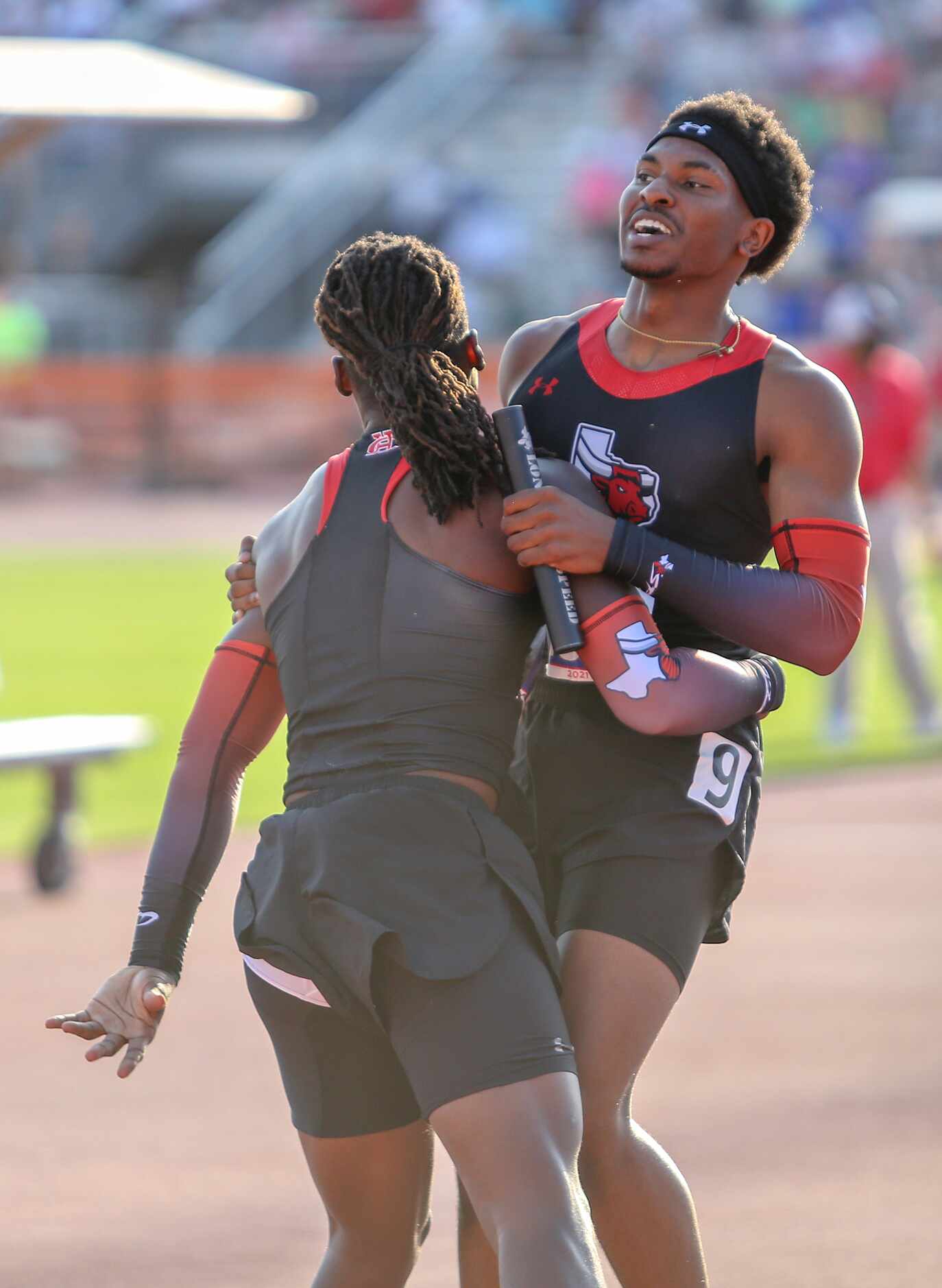 Diallo Good of Cedar Hill celebrates with a team member after they placed first in the 6A...