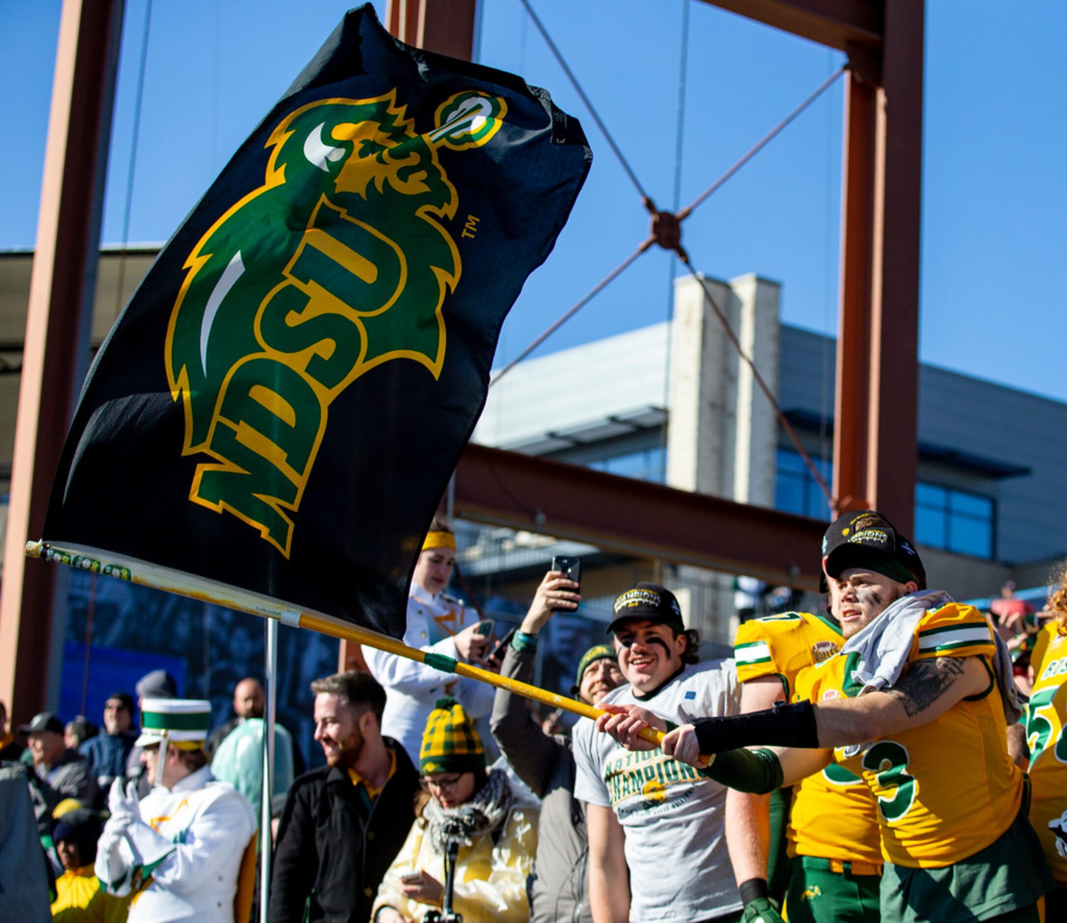 North Dakota State linebacker Jaxon Brown (3) waves a flag after beating James Madison 28-20...