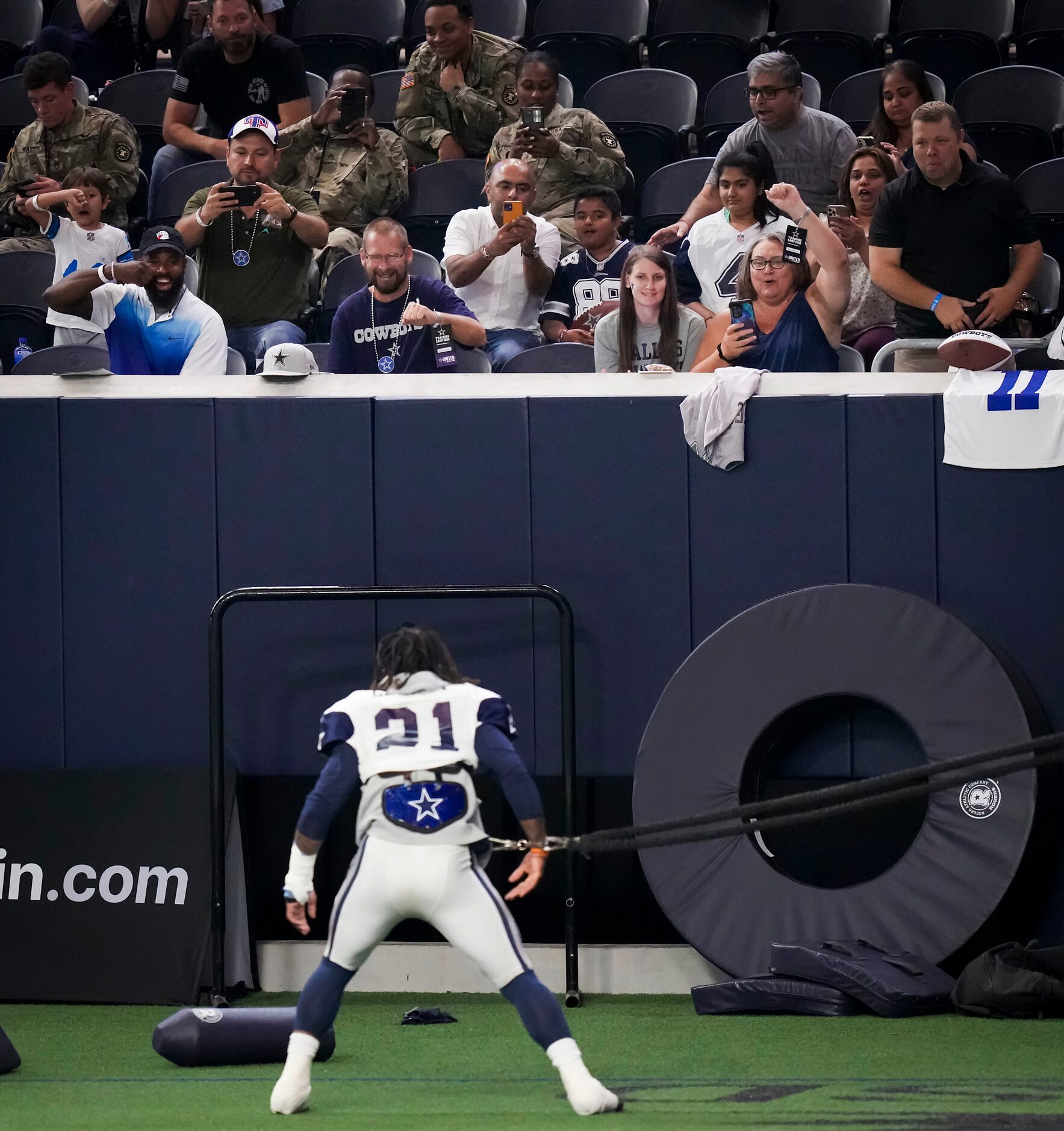 Fans cheer Dallas Cowboys running back Ezekiel Elliott (21) as he stretches during a Cowboys...