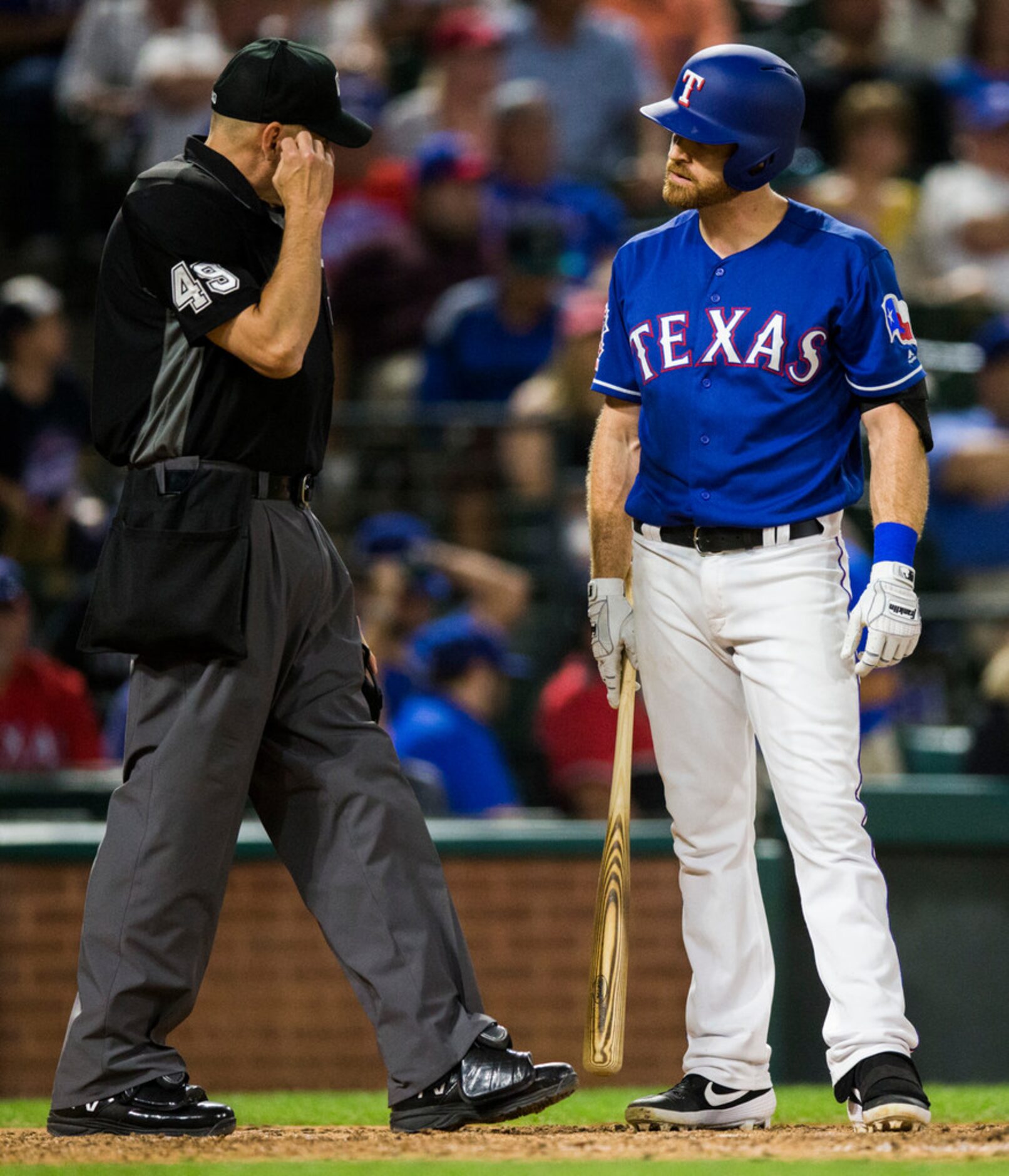 Texas Rangers short stop Logan Forsythe (41) glares at umpire Andy Fletcher (49) during the...