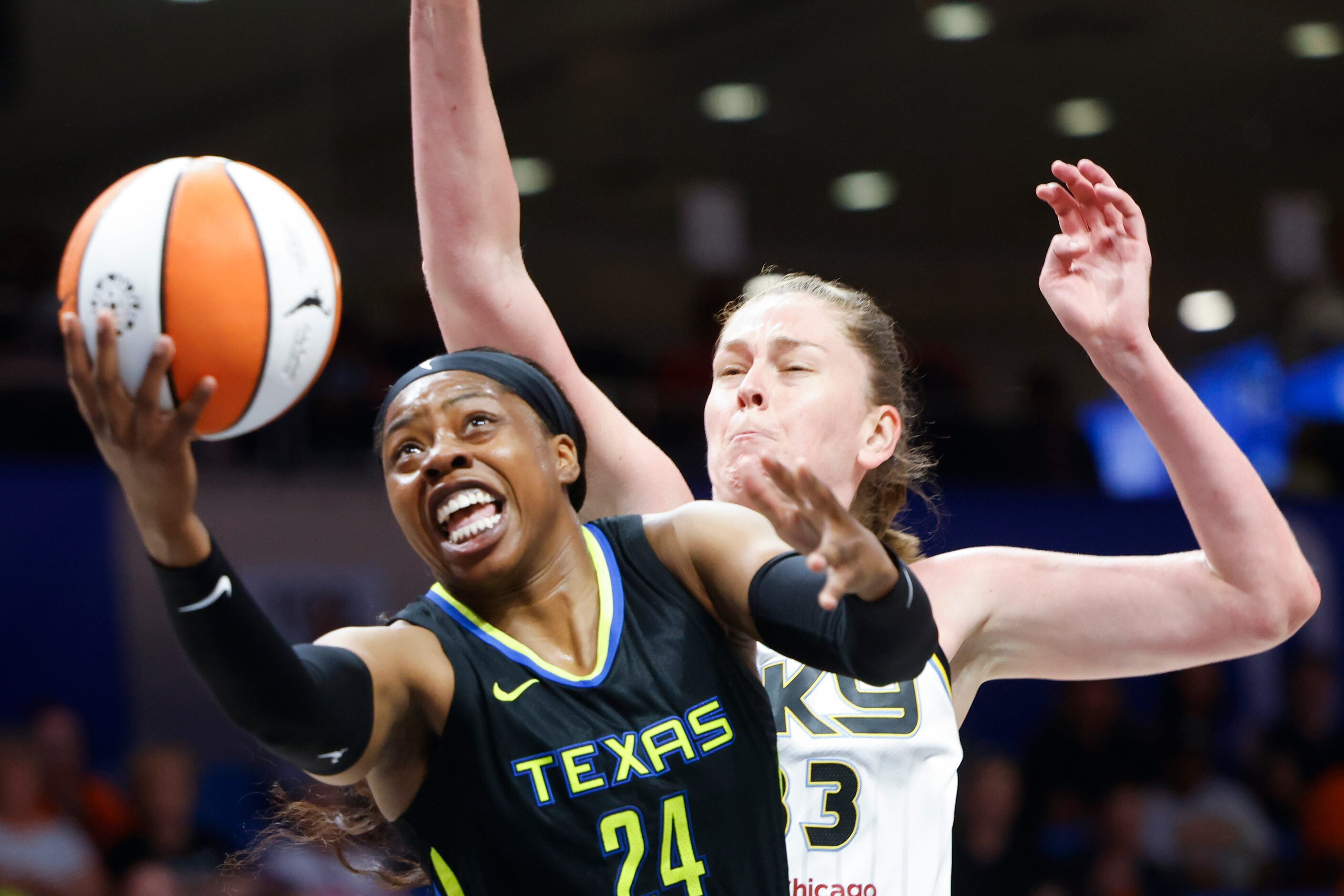 Dallas Wings guard Arike Ogunbowale, left, drives to the basket past Chicago Sky forward...