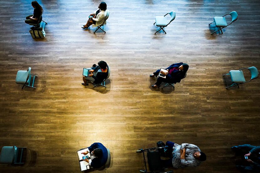 Chairs were spaced to ensure social distancing for city staff watching a video feed of a...