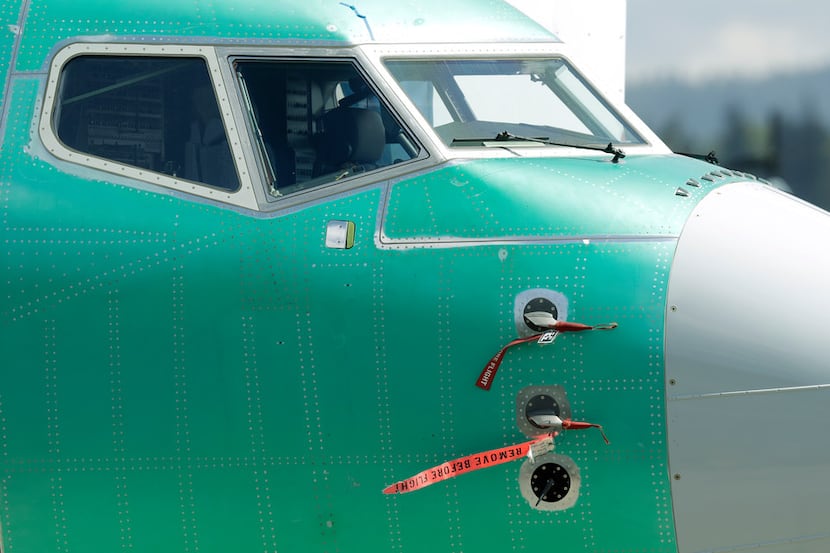 Caution flags hang from flight sensors on a Boeing 737 MAX 8 airplane being built at...