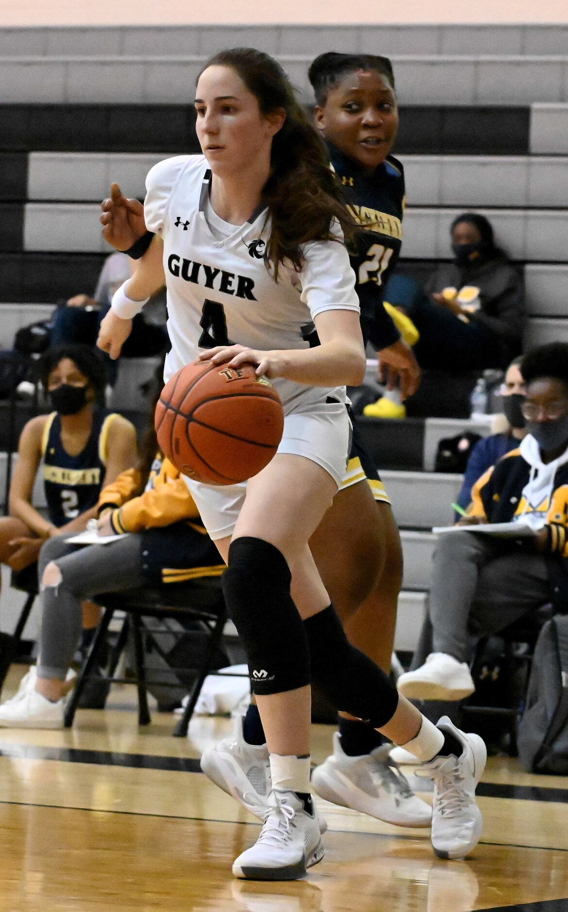 Denton Guyer’s Evie Goetz drives past McKinney’s Karlan Moore in the first half of a girls...