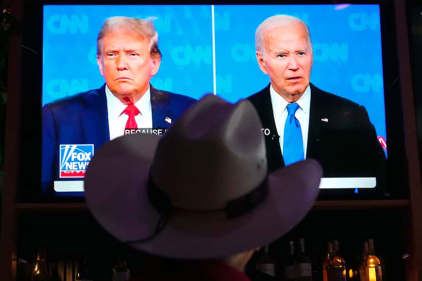 Roger Strassburg of Scottsdale, Ariz., wears a cowboy hat as he watches the presidential...