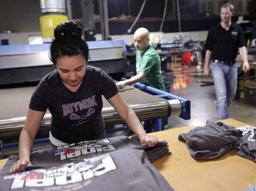 Lorena Alcantara produces NCAA championship t-shirts through the night at Pony Xpress...